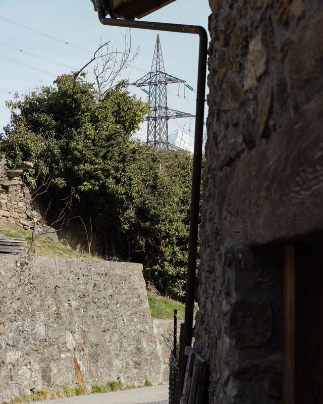 Pylon seen between walls and vegetation